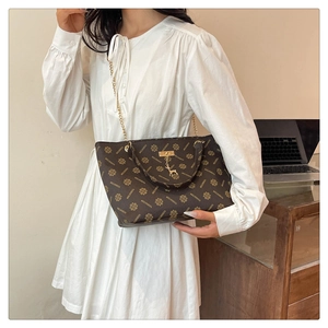 Vintage monogram tote bag with gold chain and deer pendant in premium brown finish
