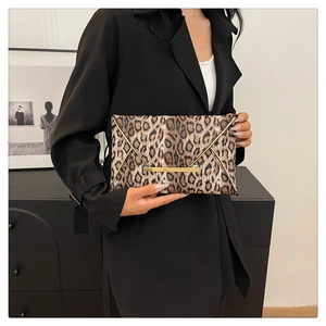 Fashionable leopard print envelope clutch featuring a triangular flap and gold metal bar buckle