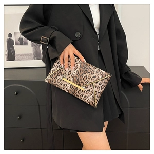 Fashionable leopard print envelope clutch with gold V-shaped metal trim and magnetic closure