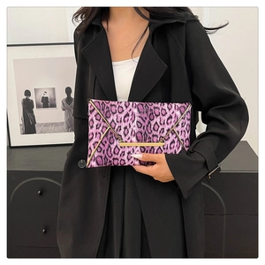 Close-up of pink leopard print envelope clutch with gold metallic trim and texture