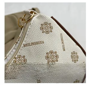 Detailed macro view of the premium gold hardware and textured leather on this shoulder bag