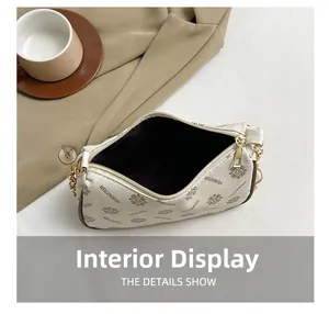 Detailed interior view of crescent bag showing spacious brown lining and golden zipper