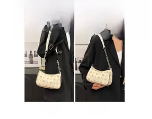Detail showing versatile styling of a cream vintage monogram chain bag for women