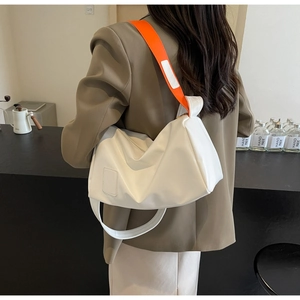 Minimalist white cylinder crossbody bag with stylish orange wide strap for women