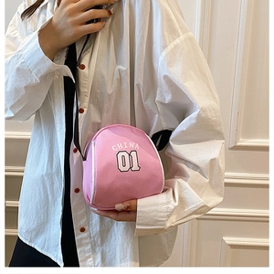 Detail of pink canvas crossbody bag with white China 01 lettering and white piping