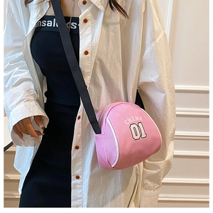 On-model shot of a pink lightweight crossbody bag with white China 01 lettering and strap