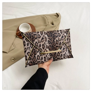 Fashionable leopard print envelope clutch bag with gold trim and magnetic metal closure