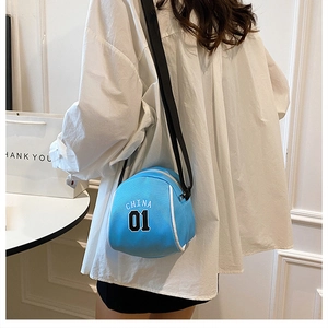 Model wearing sky blue canvas round crossbody bag with white CHINA 01 graphic print