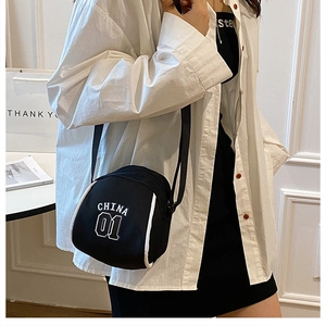 Black canvas shell crossbody bag with China 01 print and white piping detail