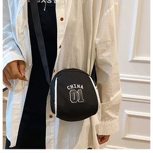 Detail of a black nylon crossbody shell bag with white CHINA 01 lettering print