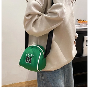 Close-up of green nylon crossbody bag with white China 01 logo and adjustable strap