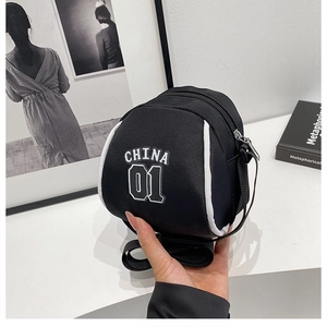Detail of black mini round composite fabric bag with white CHINA 01 print and trim