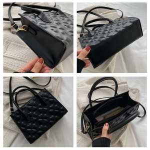 Detail view of black clover embossed handbag showing multiple angles and interior compartments