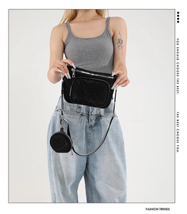 Detail of black rhinestone crossbody set with round coin purse and silver zipper hardware