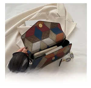 Interior storage space of a colorblock crossbody bag holding a phone and wallet