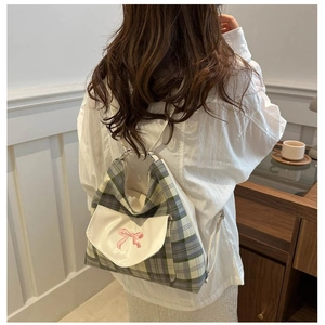 Vintage plaid backpack with white leather flap and pink bow embroidery shown on model