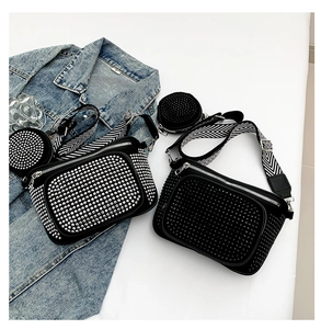 Detail view of dark style punk crossbody bag with dense studs and striped strap