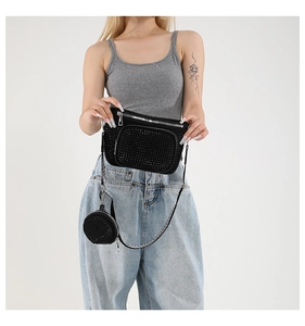 Detail of black rhinestone camera bag set with small round coin purse on shoulder strap