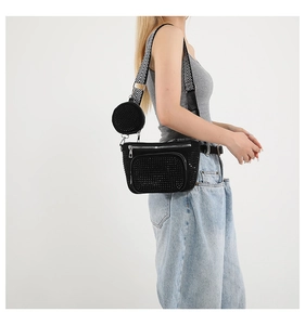 Detail of black rhinestone crossbody bag with a zigzag pattern wide shoulder strap on model