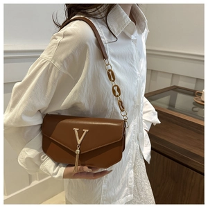 Caramel brown leather bag with golden V-logo and long metallic tassel detail