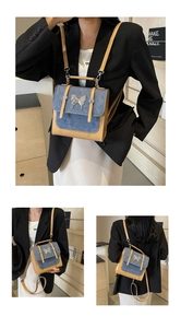 Macro detail of retro patchwork backpack with denim flap and silver butterfly clasp