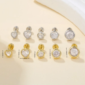 Detailed size comparison of gold and silver heart and round stud earrings with zirconia