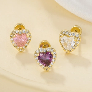 Detail of heart stud earrings with colorful zircons and pavé diamonds in gold finish