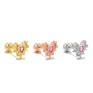 Detailed view of heart-shaped bat wing ear studs in gold, rose gold and silver finishes