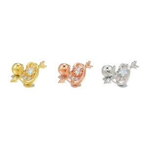 Macro detail of gold and silver moon star cartilage earrings with screw back closures