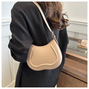 Chic beige half-moon shoulder bag in premium matte leather with U-shaped piping detail