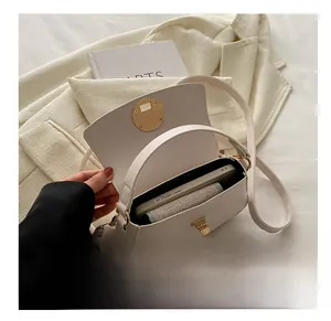 Capacity display showing a large smartphone inside a cream white flap shoulder bag
