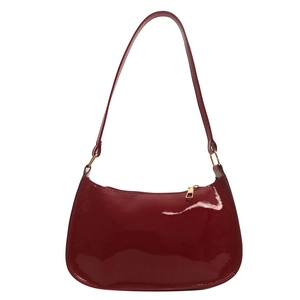 Minimalist deep red patent leather hobo bag with glossy finish and gold metal hardware