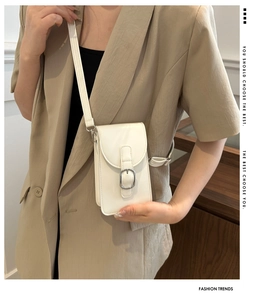 Close-up of a stylish cream white mini crossbody phone bag with a silver square buckle