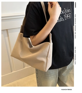 Minimalist beige nylon tote bag shown on model for a casual and stylish daily look