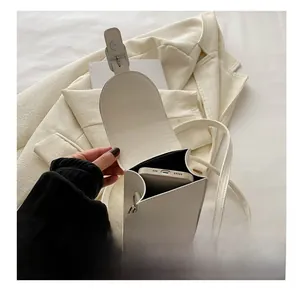 Detailed interior view of a white mini crossbody bag showing storage space for a smartphone