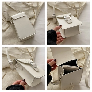 Detail view of white mini crossbody bag showing silver buckle and internal phone storage