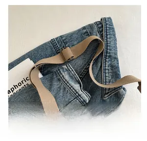 Close-up of adjustable brown woven strap and metal buckle on casual bucket bag