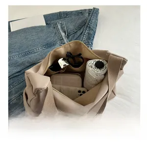 Top view of beige canvas bucket bag interior showing spacious storage with everyday essentials