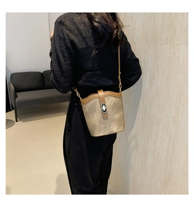 Detailed view of khaki bucket bag with water ripple texture and metallic twist lock clasp