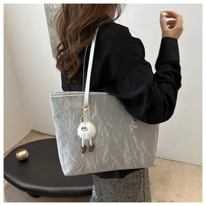 Silver wrinkled paper texture tote bag with fluffy monster charm and shoulder straps