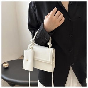 Minimalist white PU leather flap crossbody bag with woven handle and mini pouch charm