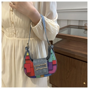 Detailed macro of woven hobo bag with colorful pop art patterns and metallic buckle