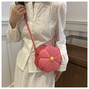 Detailed view of pink flower-shaped crossbody bag with yellow bead center and PU leather finish
