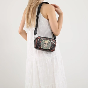 Black Halloween crossbody bag featuring Keep Creepy skull print and red bats on a model