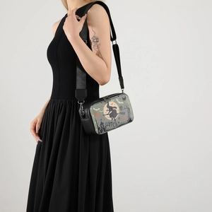 Halloween crossbody camera bag with witch print and adjustable wide strap on model