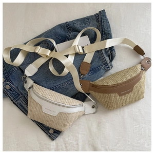 Retro straw woven waist bag with white leather trim and adjustable nylon strap on denim