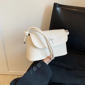 Elegant off-white rectangular crossbody bag with silver bow buckle and knotted strap