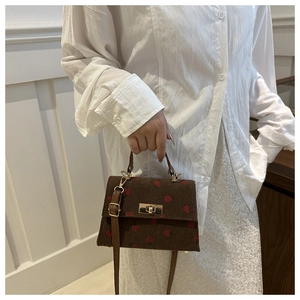 Brown corduroy handbag with strawberry pattern, vintage clasp and leather strap detail