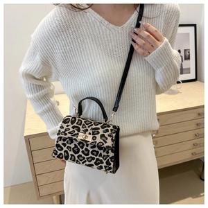 Stylish leopard print crossbody bag with gold twist lock and black leather handle