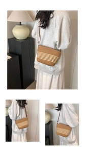 Close-up of woven straw handbag featuring tan and cream stripes with leather strap